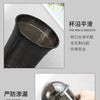 A close-up view of a black disposable U-shaped coffee cup, highlighting its smooth rim and leak-proof design.