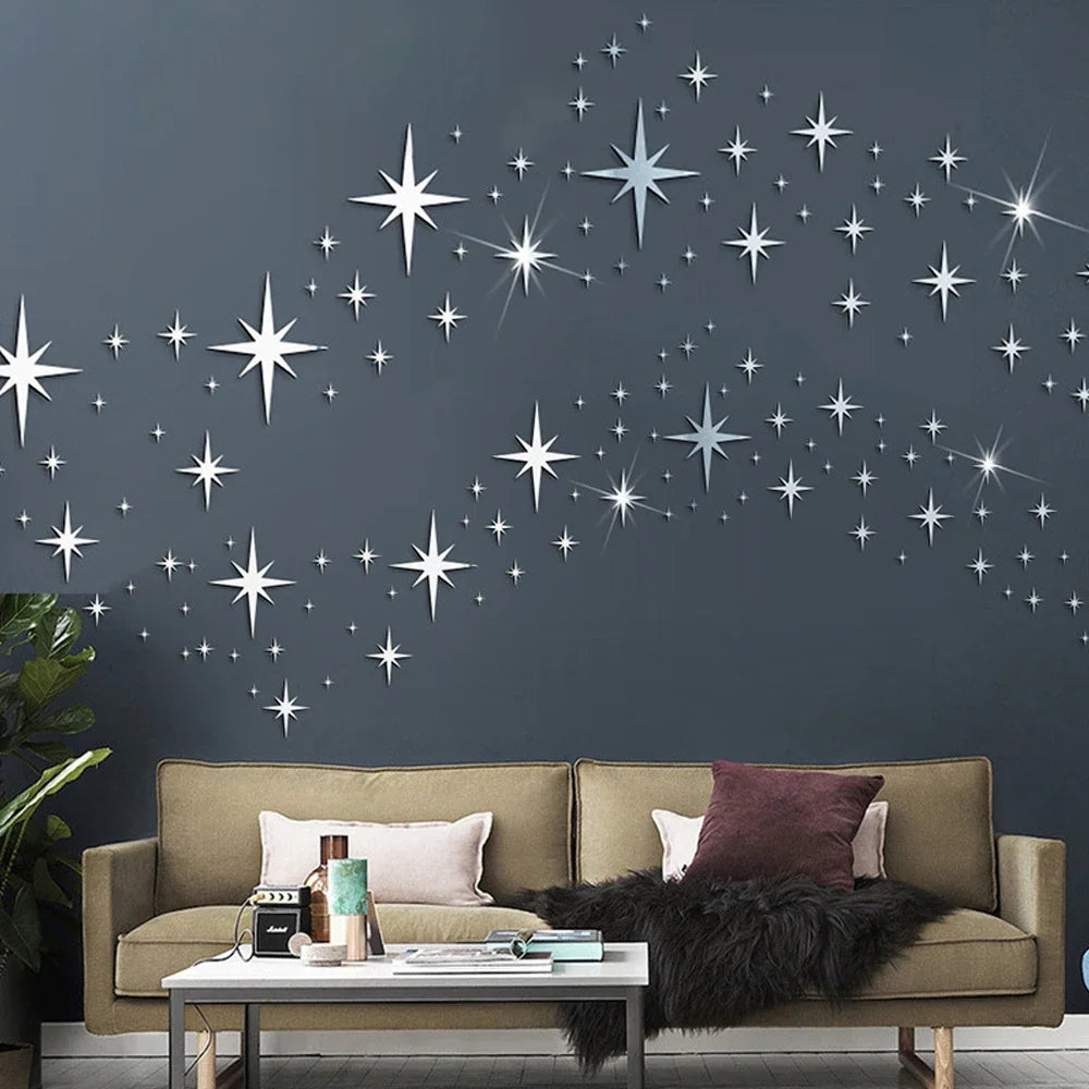 Silver star mirror wall stickers decorating a dark gray wall above a beige sofa.