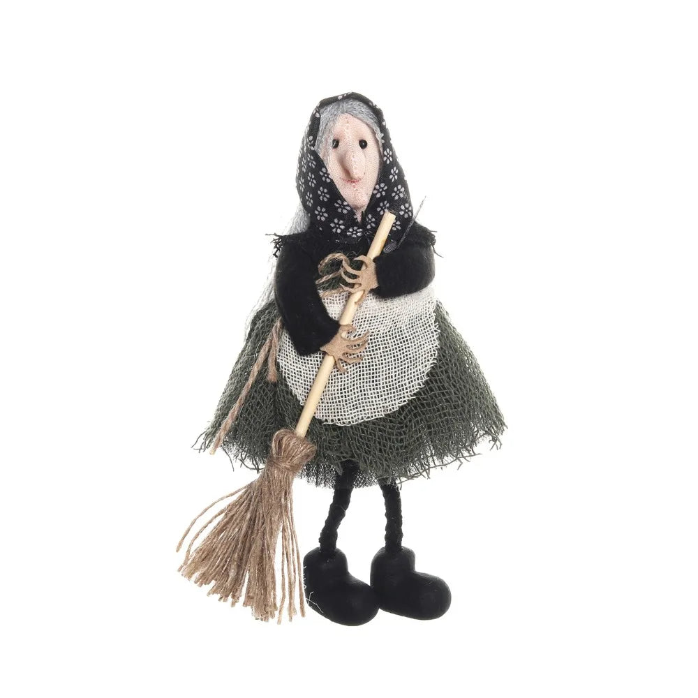 A scarecrow witch ornament featuring a stitched face, black and white fabric, and straw accents.
