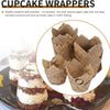A close-up of brown newspaper style cupcake wrappers and baked cupcakes.