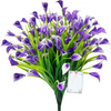 A bouquet of purple artificial calla lilies with green stems and a white card