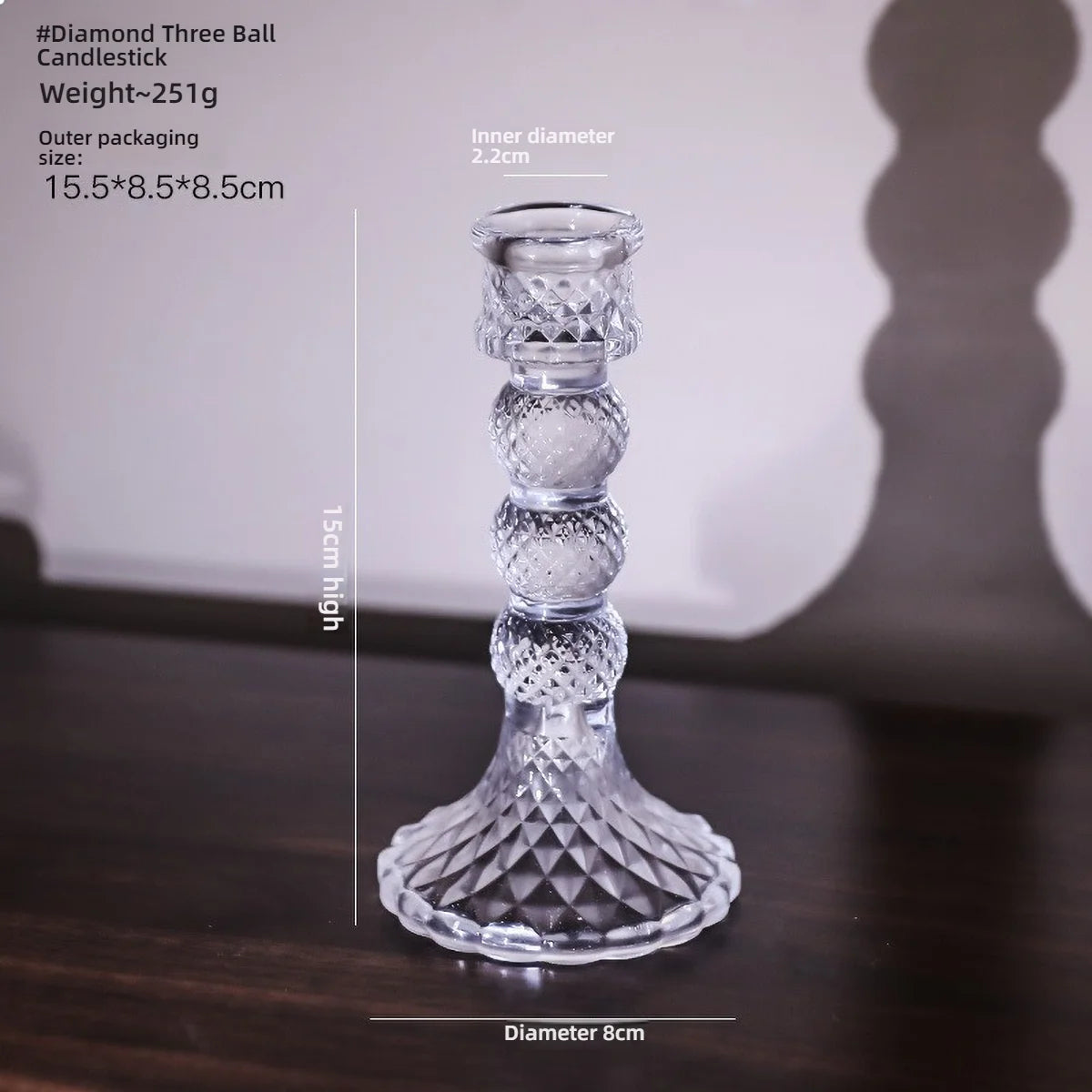 Elegant clear glass pillar candle holder with a decorative base and tapered shape.