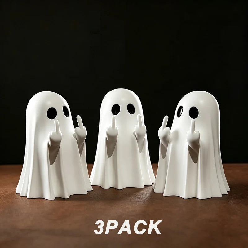 A pack of three white ghost figurines with playful poses displayed on a brown surface.
