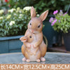 Hand-painted resin rabbit garden statue in a natural brown color sitting outdoors