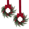 A 10-inch artificial Christmas wreath decorated with green foliage, red berries, and a red velvet bow.
