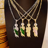 A display of multiple layered necklaces featuring silver and gold chains with ornate pendants.
