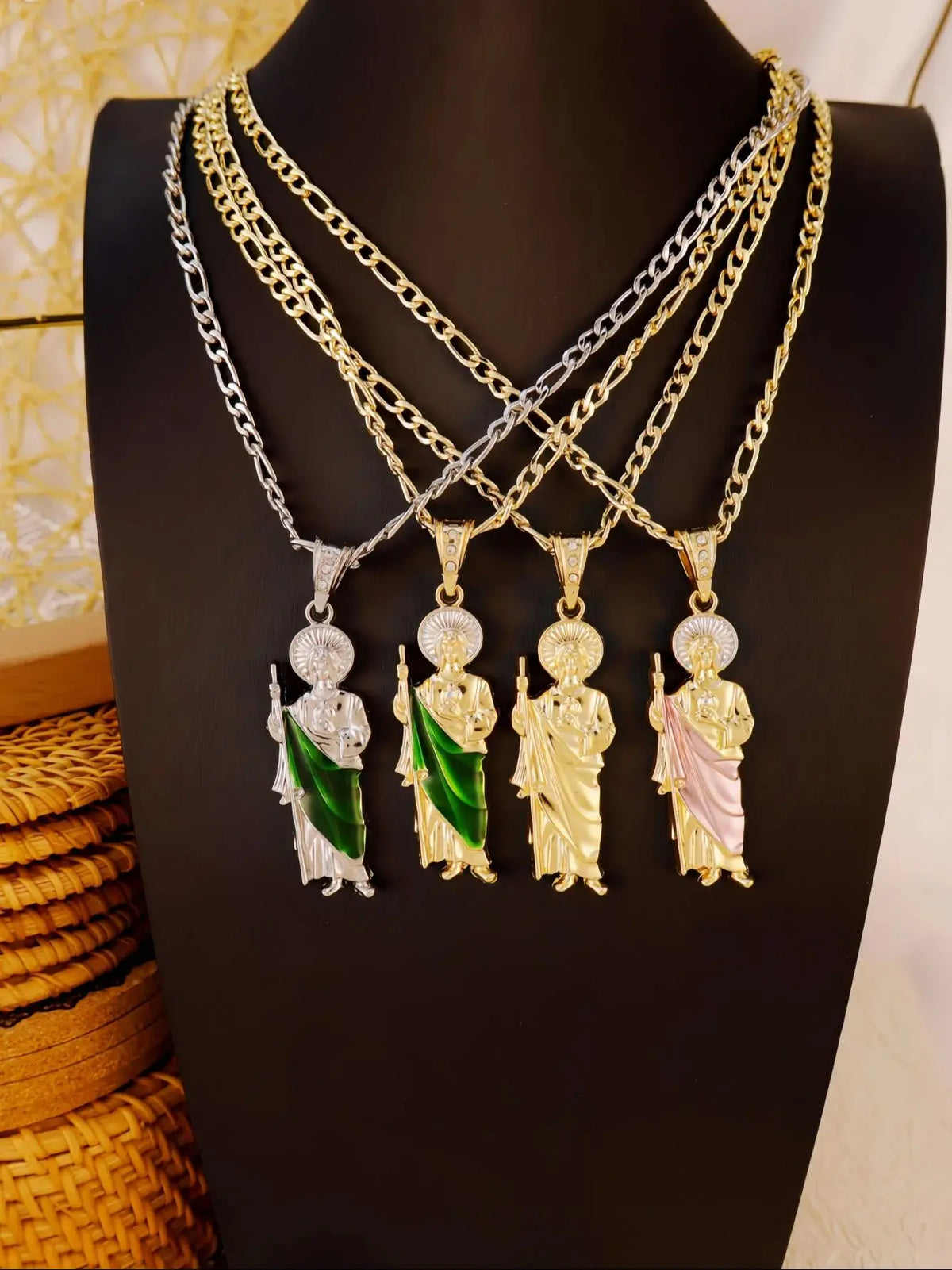 A display of multiple layered necklaces featuring silver and gold chains with ornate pendants.