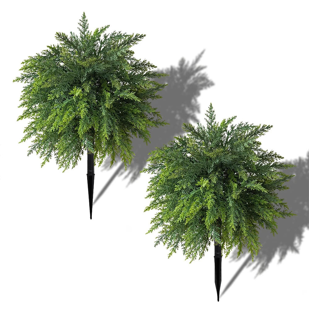 Artificial cypress topiary with green faux cedar foliage casting a shadow.