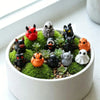 A collection of quirky mini resin duck figurines with spooky designs in various colors like red, black, orange, and white.