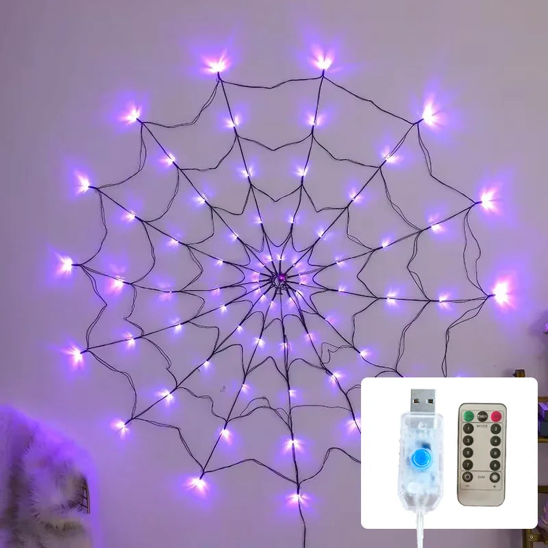 A glowing purple spider web light decoration strung on a white wall, with an LED string light power adapter shown nearby.