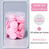 A clear plastic bucket filled with 100 pink counting tablets for educational learning.