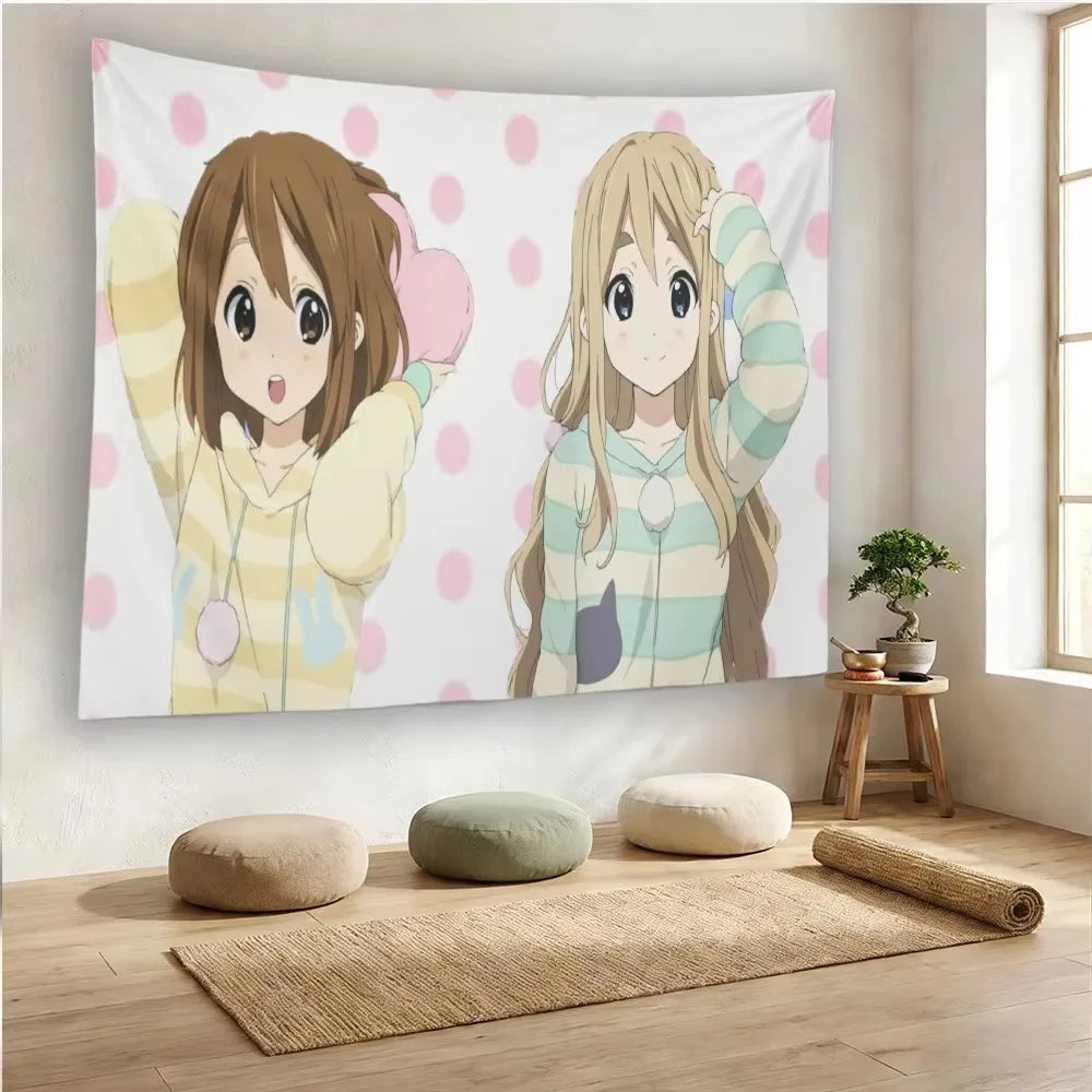 Anime wall hanging featuring two female characters in light-colored sweaters against a pink polka dot background