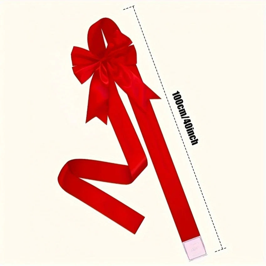 A red decorative ribbon bow shown with a measuring tape indicating 100cm or 40 inches.