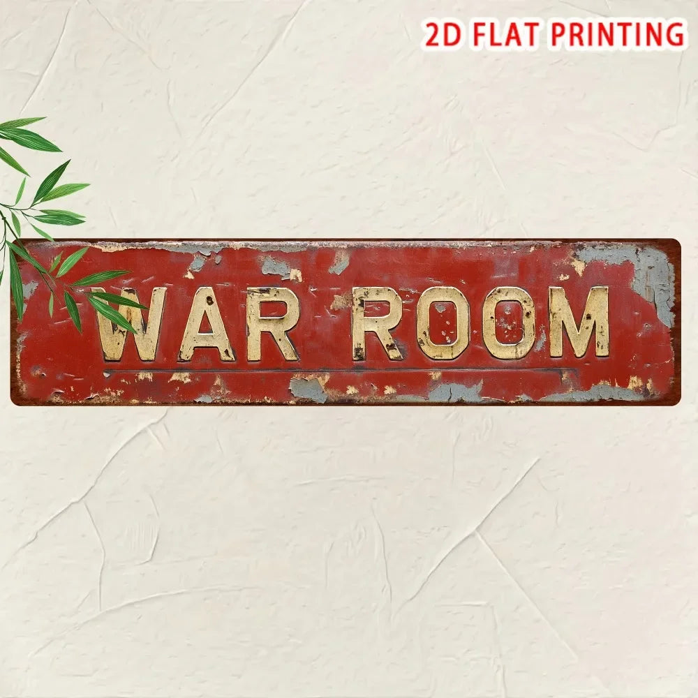 A distressed red metal tin sign with the words WAR ROOM painted in gold lettering on a light background.