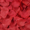 A close-up of deep red silk rose petals for weddings and special events.