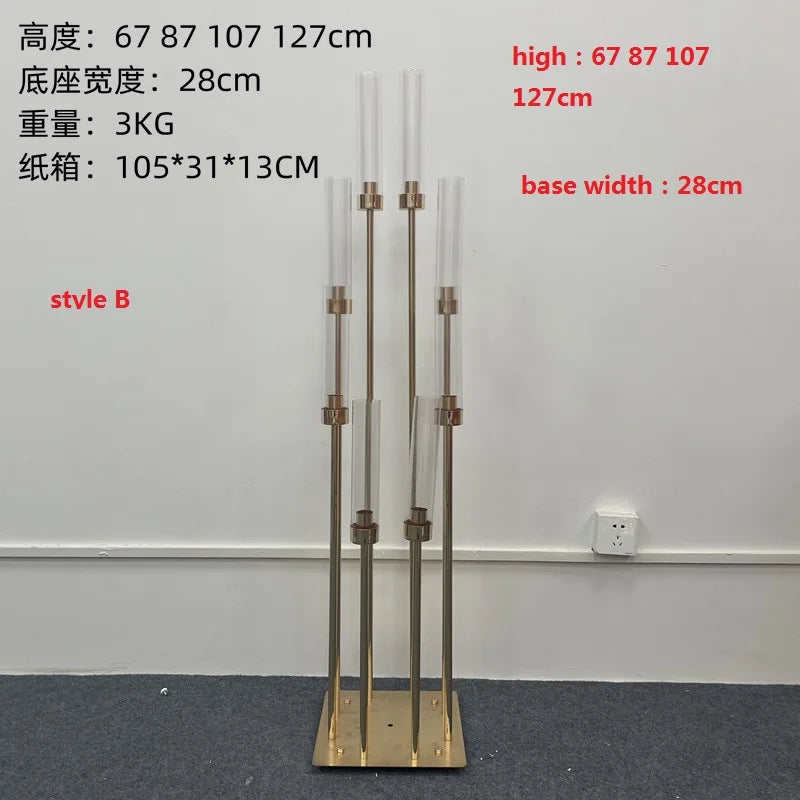 A tall gold metal candelabra set with eight slender candle holders displayed on a dark floor.