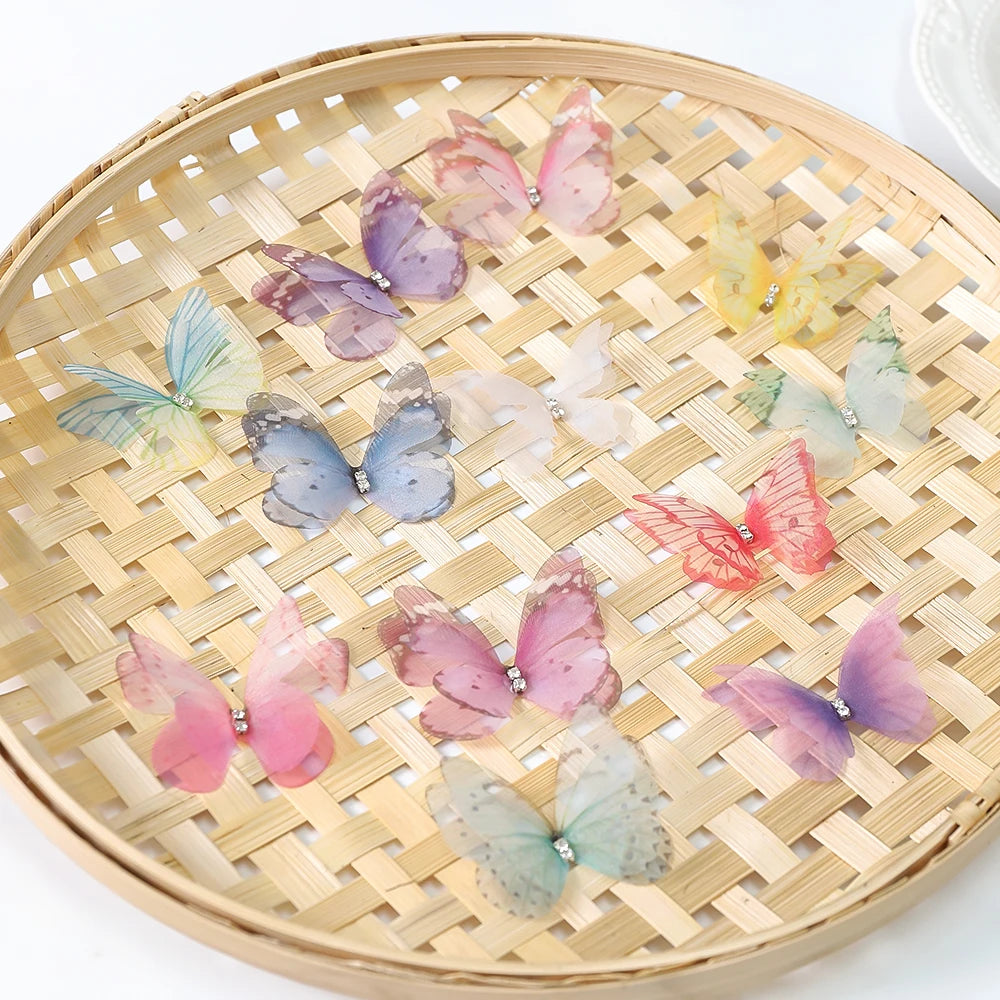 A collection of 3D embroidered butterfly patches in various shades of pink, purple, and green are displayed on a woven bamboo