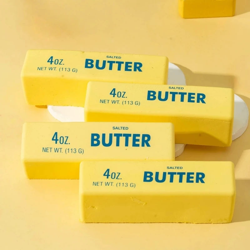 Three yellow butter squeeze toys labeled 4oz salted butter are displayed on a light background.