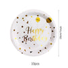Plato blanco con puntos dorados y texto 'Feliz Cumpleaños', mostrado con una marca de dimensión.