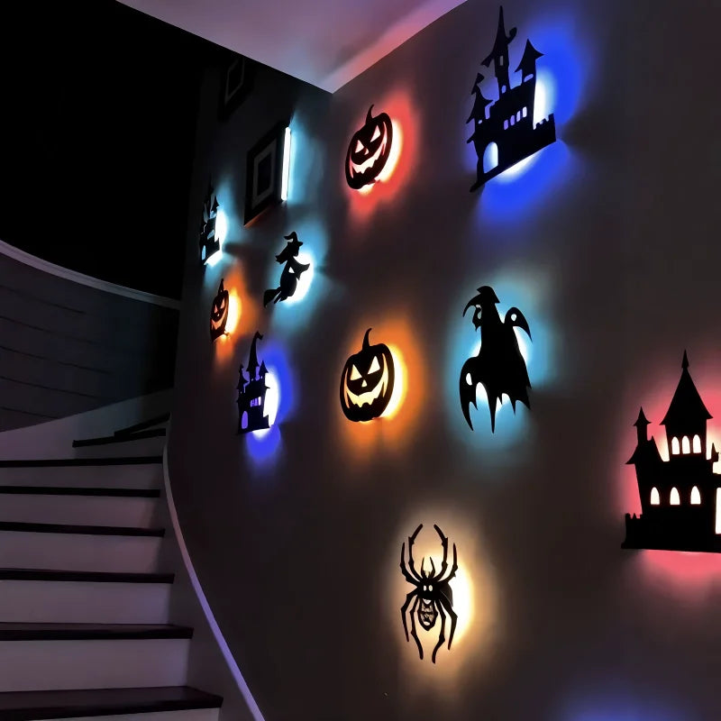A dark wall features illuminated Halloween-themed 3D stickers of a pumpkin, witch, castle, and spider.