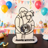 A white silhouette art piece depicting a mother and baby embracing, with the text Family Growing underneath.
