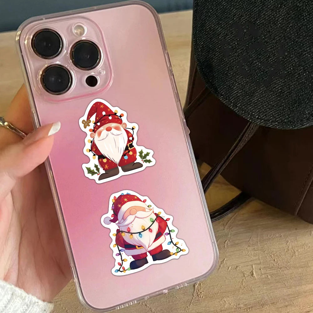 A pink smartphone features two Christmas dwarf stickers with Santa decorations on the back.