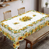 Sunflower printed tablecloth with floral pattern set on a wooden dining table.