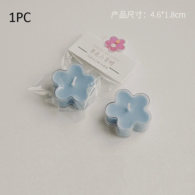 One piece of light blue handmade soy wax flower tea light candle with a pink flower charm.