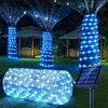 A long, cylindrical rope light made of blue LED strands is displayed outdoors on grass.