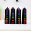 Four black obsidian crystal towers displaying various colored gemstone symbols for meditation and home decor