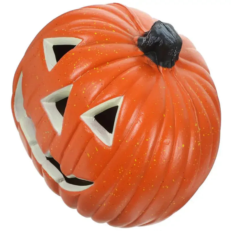An orange carved pumpkin with a black nose and white facial markings, used as a Halloween lantern.