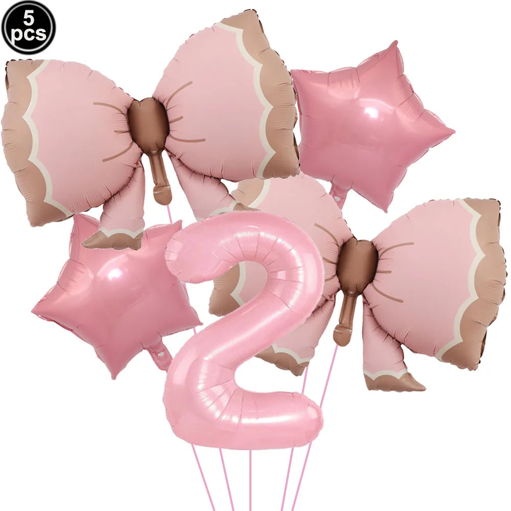 A set of pink bow shaped balloons and a pink number 2 balloon for a party decoration