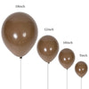 A collection of latex balloons in varying sizes, including 18 inch, 12 inch, 10 inch, and 5 inch, in a sand or beige color.