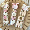 Clear cellophane gift bags with pink and white ribbons hold cookies, candies, and party favors