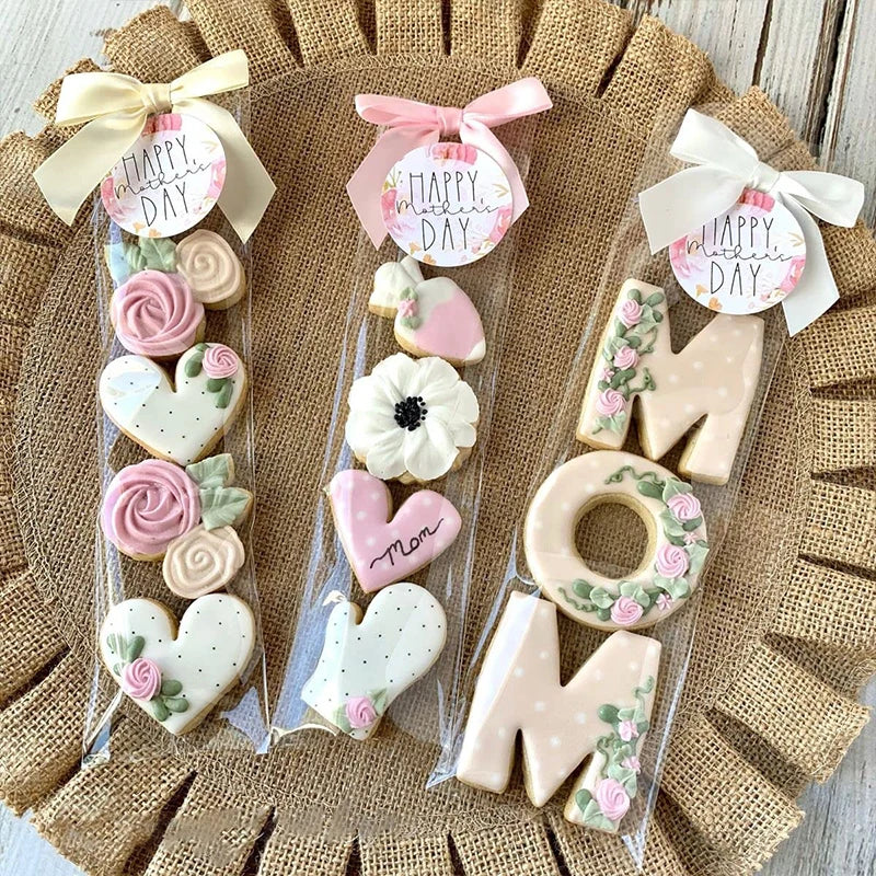 Clear cellophane gift bags with pink and white ribbons hold cookies, candies, and party favors