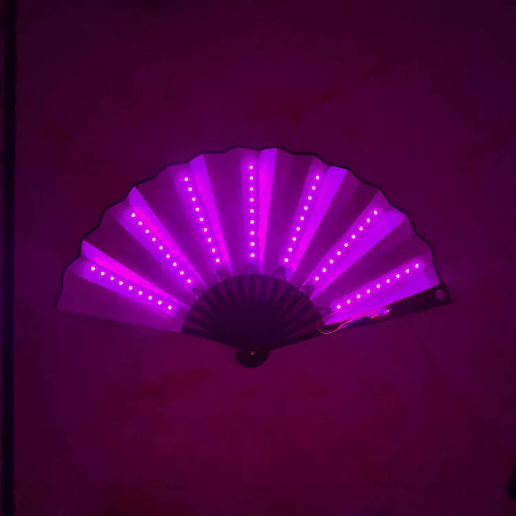 An illuminated folding hand fan with purple LED lights is displayed against a dark background.