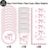 A set of pink bow themed birthday party supplies including plates cups and napkins