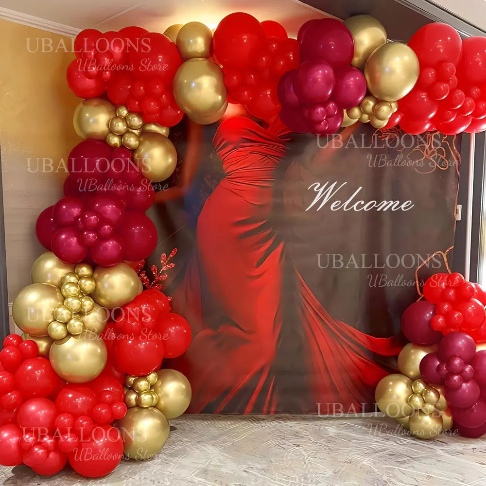 A vibrant arrangement of deep burgundy and gold latex balloons forming a welcome display.