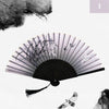 A black and white photograph of a vintage silk bamboo folding hand fan with delicate plant details.