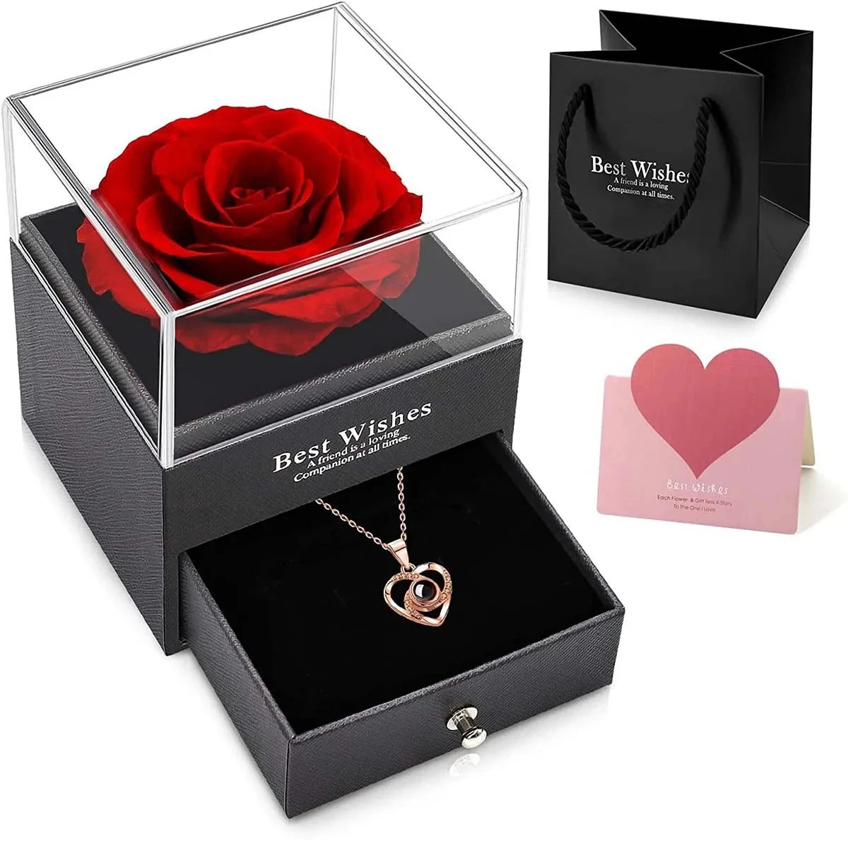 Un coffret cadeau avec une rose rouge conservée et un collier dans une boîte noire avec une carte rose.