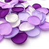 Una colección de pétalos de flores de seda artificial en tonos morados y lavanda.