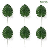 Six artificial green tropical palm leaves used for party decoration