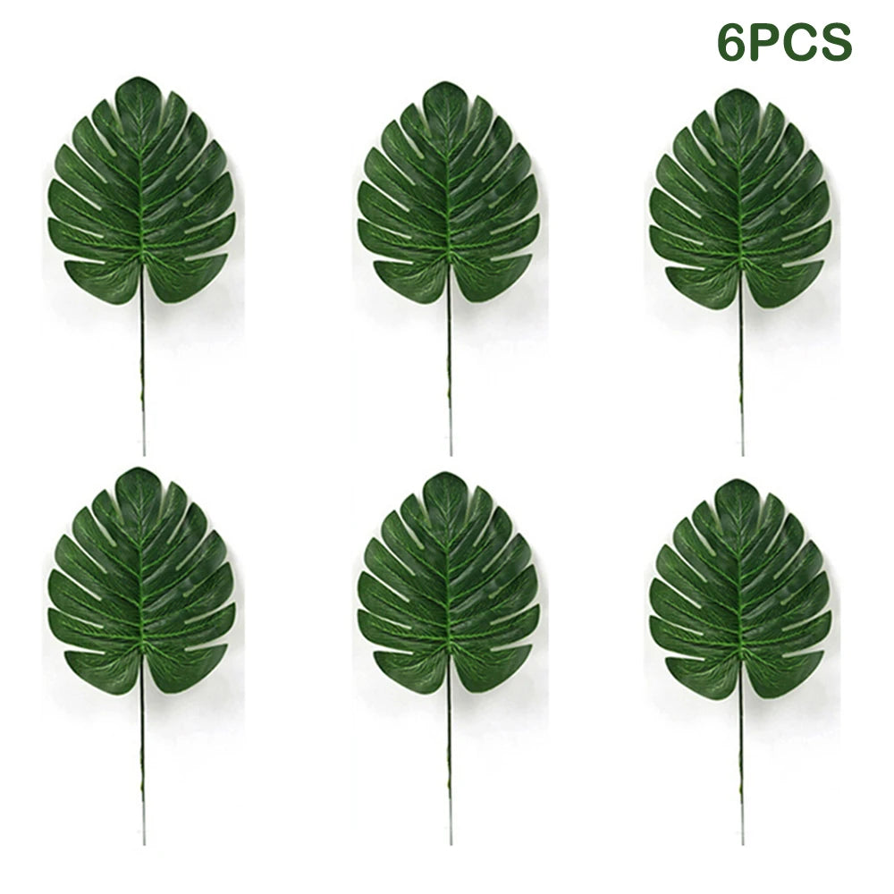 Six artificial green tropical palm leaves used for party decoration