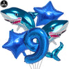A set of blue shark foil balloons and a blue number nine balloon for an ocean-themed party decoration