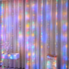 Purple and pink sheer curtains decorated with twinkling fairy lights
