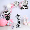 A set of cow print number balloons and decorations for a party