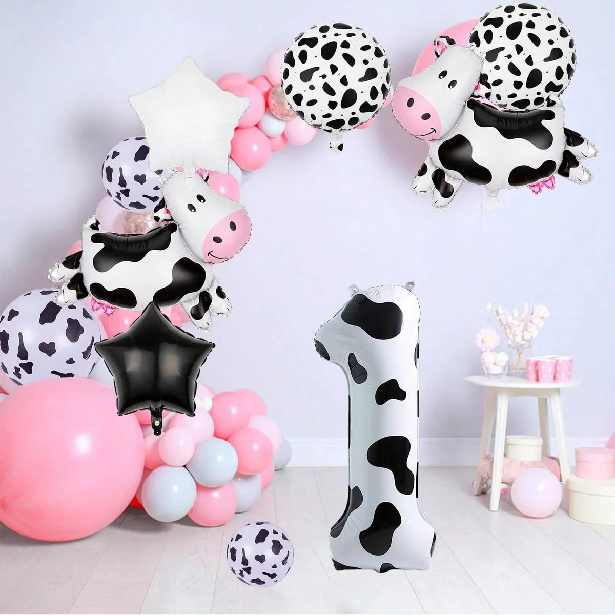 A set of cow print number balloons and decorations for a party