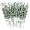 A bunch of artificial eucalyptus leaves with long stems used for home decor or events.