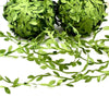 Two spherical bundles of artificial green climbing vine foliage