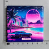 A glossy magnet featuring a vibrant purple and pink sunset over the ocean with a palm tree and city skyline, labeled Miami.